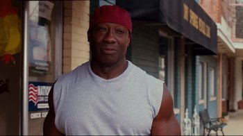 Movie still from “Welcome Home, Roscoe Jenkins” (2008), directed by Malcolm D. Lee – A black man wearing a red hat and a white shirt; Close Up shot, Low angle