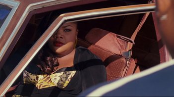 Movie still from “Welcome Home, Roscoe Jenkins” (2008), directed by Malcolm D. Lee – A woman sitting in the passenger seat of a car; Medium shot, High angle