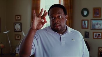 Movie still from “Welcome Home, Roscoe Jenkins” (2008), directed by Malcolm D. Lee – A man holding up a red object in front of his face; Close Up shot, High angle
