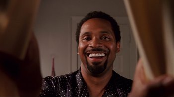 Movie still from “Welcome Home, Roscoe Jenkins” (2008), directed by Malcolm D. Lee – A person smiling in a mirror; Close Up shot, Low angle