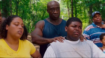 Movie still from “Welcome Home, Roscoe Jenkins” (2008), directed by Malcolm D. Lee – A group of people standing in a forest; Medium shot, Low angle