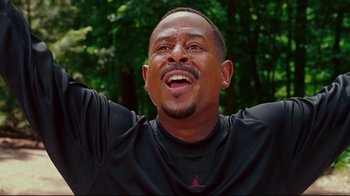 Movie still from “Welcome Home, Roscoe Jenkins” (2008), directed by Malcolm D. Lee – A person with his hands raised; Close Up shot, Low angle