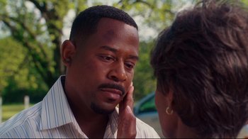 Movie still from “Welcome Home, Roscoe Jenkins” (2008), directed by Malcolm D. Lee – A black man with his hand to his face; Close Up shot, Over the shoulder angle