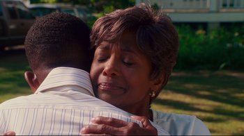 Movie still from “Welcome Home, Roscoe Jenkins” (2008), directed by Malcolm D. Lee – An older woman is hugging a younger man outside; Close Up shot, Over the shoulder angle