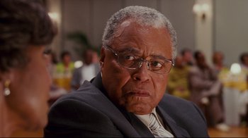 Movie still from “Welcome Home, Roscoe Jenkins” (2008), directed by Malcolm D. Lee – An older man in a suit and tie; Close Up shot, Low angle