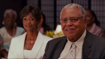 Movie still from “Welcome Home, Roscoe Jenkins” (2008), directed by Malcolm D. Lee – An older man and a younger woman smiling for the camera; Close Up shot, Over the shoulder angle