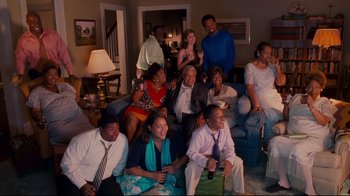 Movie still from “Welcome Home, Roscoe Jenkins” (2008), directed by Malcolm D. Lee – A group of people sitting on top of a blue couch; Wide shot, High angle