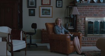Movie still from “Welcome to the Rileys” (2010), directed by Jake Scott – A woman sitting in a chair in a living room; Wide shot, High angle