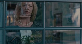Movie still from “Welcome to the Rileys” (2010), directed by Jake Scott – A woman looking out of a window at a plant; Medium shot, Over the shoulder angle