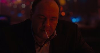 Movie still from “Welcome to the Rileys” (2010), directed by Jake Scott – A man is smoking a cigarette in a dark room; Close Up shot, Over the shoulder angle