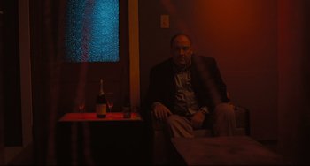 Movie still from “Welcome to the Rileys” (2010), directed by Jake Scott – A man sitting on a couch in front of a window; Medium shot, Low angle