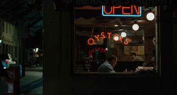 Movie still from “Welcome to the Rileys” (2010), directed by Jake Scott – A man sitting in front of a restaurant window; Wide shot, Over the shoulder angle