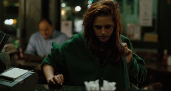 Movie still from “Welcome to the Rileys” (2010), directed by Jake Scott – A woman in a green jacket is at a bar; Medium shot, Over the shoulder angle