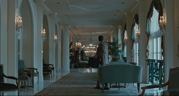 Movie still from “Welcome to the Rileys” (2010), directed by Jake Scott – A person standing in a room holding a suitcase; Extreme Wide shot, Low angle