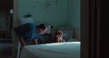 Movie still from “Welcome to the Rileys” (2010), directed by Jake Scott – A man standing next to a woman in a bed; Medium shot, High angle