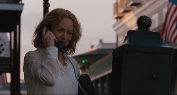 Movie still from “Welcome to the Rileys” (2010), directed by Jake Scott – A woman talking on a phone while standing on a street; Close Up shot, Low angle