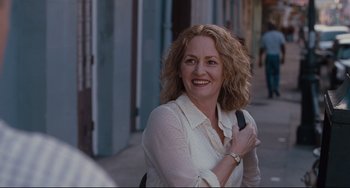 Movie still from “Welcome to the Rileys” (2010), directed by Jake Scott – A woman smiles while holding a cell phone; Close Up shot, Over the shoulder angle
