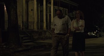 Movie still from “Welcome to the Rileys” (2010), directed by Jake Scott – A man and a woman standing on the sidewalk at night in front of a building; Wide shot, Low angle