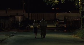 Movie still from “Welcome to the Rileys” (2010), directed by Jake Scott – A man and a woman walking down a street at night; Wide shot, Over the shoulder angle