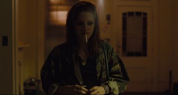 Movie still from “Welcome to the Rileys” (2010), directed by Jake Scott – A woman is smoking a cigarette in a dark room; Medium shot, Over the shoulder angle