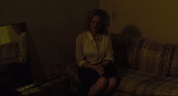 Movie still from “Welcome to the Rileys” (2010), directed by Jake Scott – A woman sitting on top of a couch in a room; Medium shot, High angle