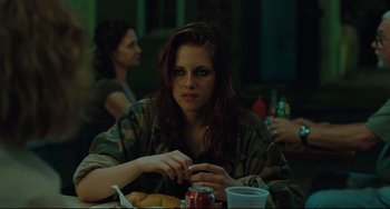 Movie still from “Welcome to the Rileys” (2010), directed by Jake Scott – A woman sitting at a table eating a hot dog; Medium shot, Over the shoulder angle