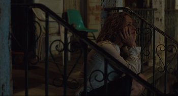 Movie still from “Welcome to the Rileys” (2010), directed by Jake Scott – A woman sitting on a chair talking on the phone; Medium shot, High angle