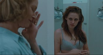 Movie still from “Welcome to the Rileys” (2010), directed by Jake Scott – A woman looking at herself in the mirror in front of a mirror; Medium shot, Over the shoulder angle
