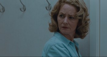 Movie still from “Welcome to the Rileys” (2010), directed by Jake Scott – An older woman in a blue shirt is looking at the camera; Close Up shot, Over the shoulder angle