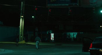 Movie still from “Welcome to the Rileys” (2010), directed by Jake Scott – A man walking across a street at night; Extreme Wide shot, Low angle