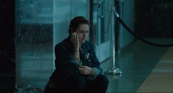 Movie still from “Welcome to the Rileys” (2010), directed by Jake Scott – A woman sitting on the ground talking on a cell phone; Medium shot, High angle