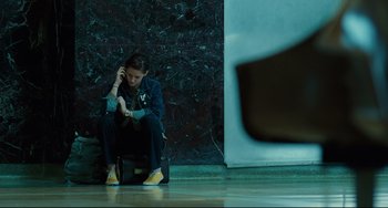 Movie still from “Welcome to the Rileys” (2010), directed by Jake Scott – A woman sitting on a chair talking on a phone; Wide shot, Low angle