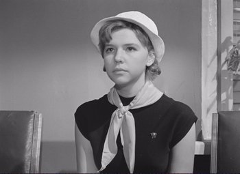Movie still from “Welcome, or No Trespassing” (1964), directed by Elem Klimov – A young woman wearing a white hat and a black shirt; Close Up shot, High angle