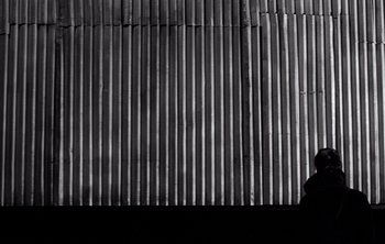 Movie still from “Werckmeister Harmonies” (2000), directed by Ágnes Hranitzky – A black and white photo of a man standing in front of a wall; Extreme Wide shot, Low angle