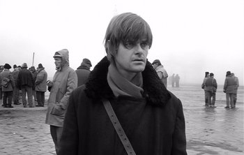 Movie still from “Werckmeister Harmonies” (2000), directed by Ágnes Hranitzky – Black and white photograph of a man in a coat; Close Up shot, Over the shoulder angle