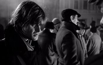 Movie still from “Werckmeister Harmonies” (2000), directed by Ágnes Hranitzky – A group of men standing next to each other; Close Up shot, Low angle