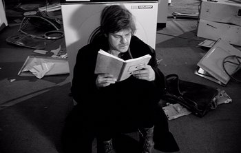 Movie still from “Werckmeister Harmonies” (2000), directed by Ágnes Hranitzky – A woman sitting on the floor reading a book; Medium shot, Low angle