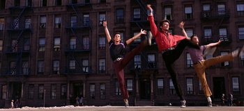 Movie still from “West Side Story” (1961), directed by Jerome Robbins – A couple of people that are dancing in the street; Wide shot, Low angle