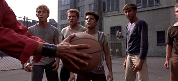 Movie still from “West Side Story” (1961), directed by Jerome Robbins – A group of young men standing next to each other on a street; Medium shot, Over the shoulder angle