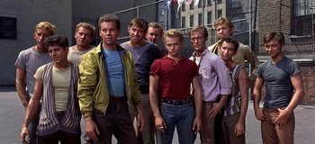 Movie still from “West Side Story” (1961), directed by Jerome Robbins – A group of young men standing next to each other; Medium shot, High angle