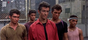 Movie still from “West Side Story” (1961), directed by Jerome Robbins – A group of young men standing next to each other; Medium shot, Low angle