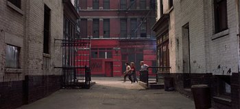 Movie still from “West Side Story” (1961), directed by Jerome Robbins – Two people walking down a street in a city; Extreme Wide shot, High angle