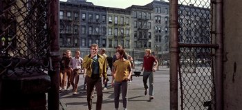 Movie still from “West Side Story” (1961), directed by Jerome Robbins – A group of young men running down a street; Wide shot, High angle