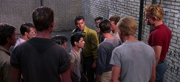 Movie still from “West Side Story” (1961), directed by Jerome Robbins – A group of young men standing next to each other in front of a brick wall; Medium shot, High angle