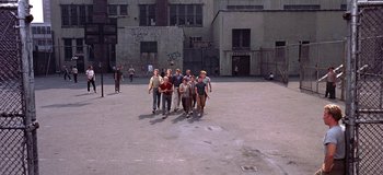 Movie still from “West Side Story” (1961), directed by Jerome Robbins – A group of people standing in an empty lot; Extreme Wide shot, High angle