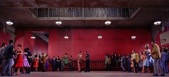 Movie still from “West Side Story” (1961), directed by Jerome Robbins – A group of people standing in front of a red wall; Extreme Wide shot, Low angle