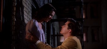 Movie still from “West Side Story” (1961), directed by Jerome Robbins – A man and a woman standing next to each other; Medium shot, Low angle