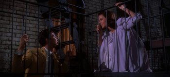 Movie still from “West Side Story” (1961), directed by Jerome Robbins – A woman and a man standing next to each other on stairs; Medium shot, Low angle