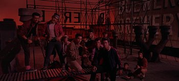 Movie still from “West Side Story” (1961), directed by Jerome Robbins – A group of young men standing next to each other; Wide shot, Low angle