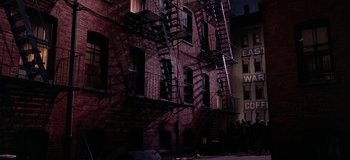 Movie still from “West Side Story” (1961), directed by Jerome Robbins – Fire escapes on the side of a building at night; Extreme Wide shot, High angle